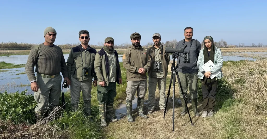 Iman Ebrahimi at Mazandaran waterbird census with his team from Department of Environment rangers and AvayeBoom field staff during the 2026 survey.