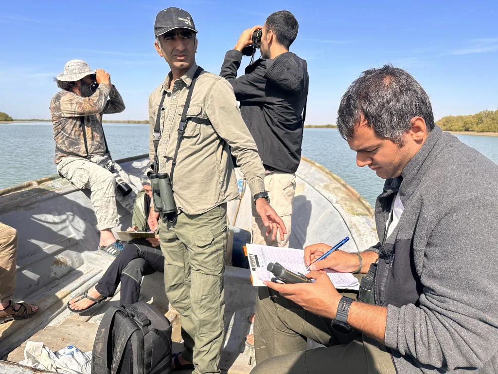 Iman Ebrahimi with team members during a waterbird census by boat in the mangrove forests of Hormozgan, southern Iran.
