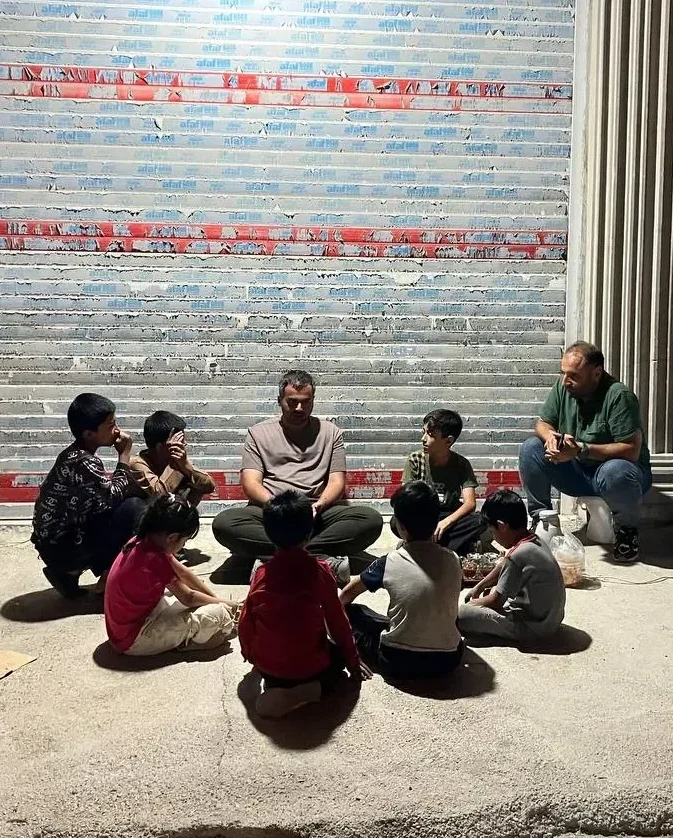 Iman Ebrahimi with locals in Iran War