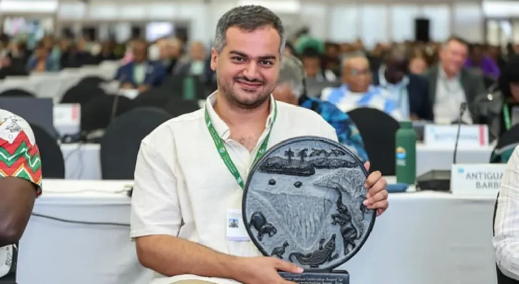 Iman Ebrahimi holding the Ramsar Wetland Conservation Award at the Convention on Wetlands COP15.